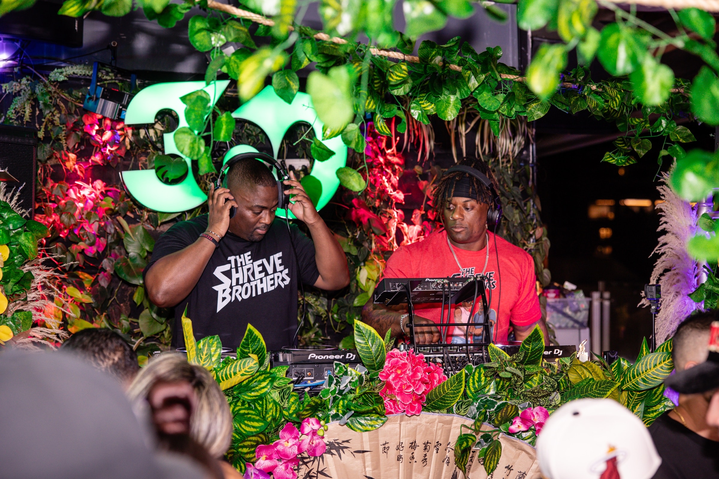 The Shreve Brothers behind the decks, tropical stage backdrop